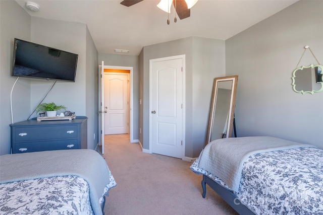 bedroom featuring a ceiling fan, light carpet, baseboards, and visible vents