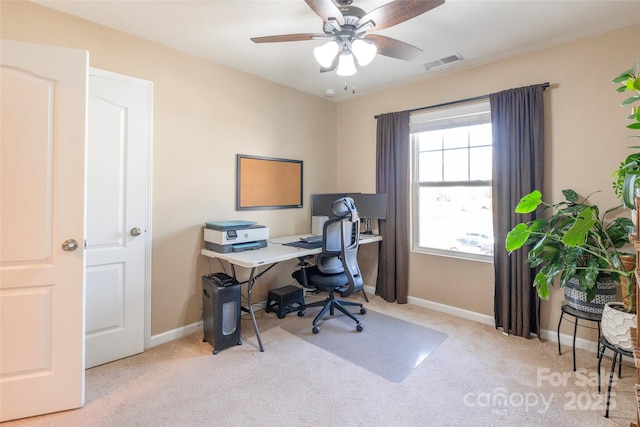 office space featuring baseboards, carpet floors, visible vents, and a ceiling fan