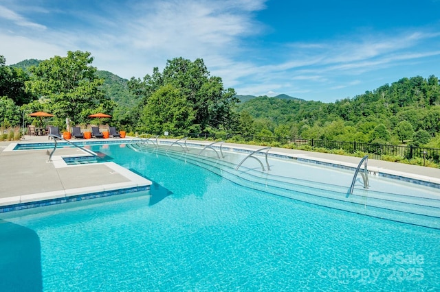 58 Country Cottage Ln, Canton, NC 28716 - pool featuring a wooded view, a patio area, and fence