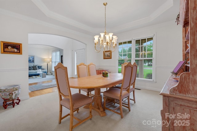 1102 High Brook Dr, Waxhaw, NC 28173 - dining space featuring arched walkways, crown molding, light colored carpet, a raised ceiling, and a chandelier