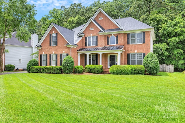 1102 High Brook Dr, Waxhaw, NC 28173 - georgian-style home featuring brick siding, covered porch, and a standing seam roof