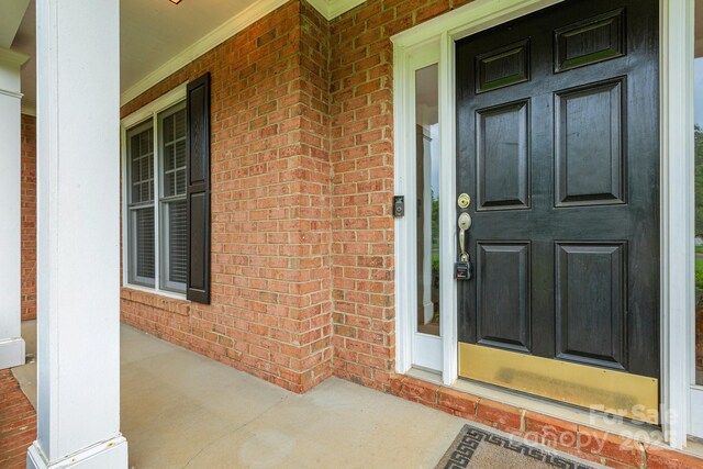 1102 High Brook Dr, Waxhaw, NC 28173 - view of exterior entry featuring covered porch and brick siding