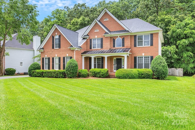 1102 High Brook Dr, Waxhaw, NC 28173 - colonial home with brick siding, a porch, and a standing seam roof