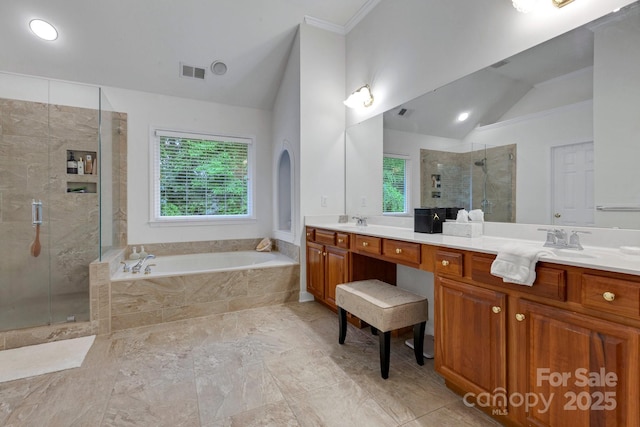 1102 High Brook Dr, Waxhaw, NC 28173 - bathroom featuring vaulted ceiling, double vanity, a shower stall, a garden tub, and crown molding