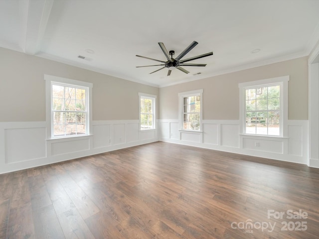 unfurnished room featuring a ceiling fan, dark wood-type flooring, crown molding, and visible vents