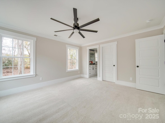 unfurnished bedroom with visible vents, ornamental molding, baseboards, and light carpet