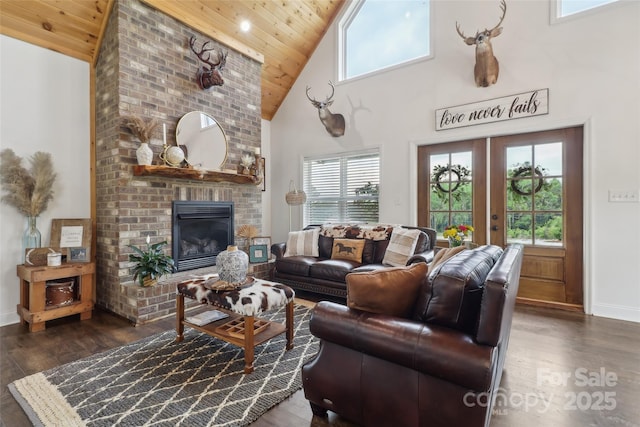 living room featuring wooden ceiling, wood finished floors, high vaulted ceiling, and baseboards