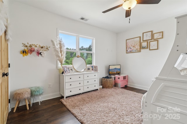 bedroom with dark wood finished floors, visible vents, ceiling fan, and baseboards
