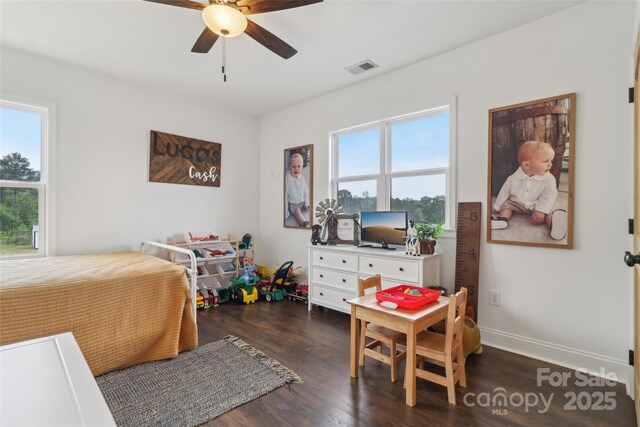 bedroom featuring baseboards, visible vents, wood finished floors, and a ceiling fan