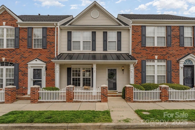 1720 Chamberside Dr, Rock Hill, SC 29730 - townhome / multi-family property with a fenced front yard, covered porch, a standing seam roof, and brick siding
