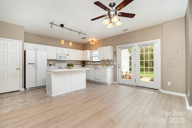 1720 Chamberside Dr, Rock Hill, SC 29730 - kitchen with light countertops, white appliances, a kitchen island, ceiling fan, and white cabinets