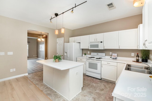 1720 Chamberside Dr, Rock Hill, SC 29730 - kitchen featuring a sink, a kitchen island, white cabinetry, white appliances, and visible vents