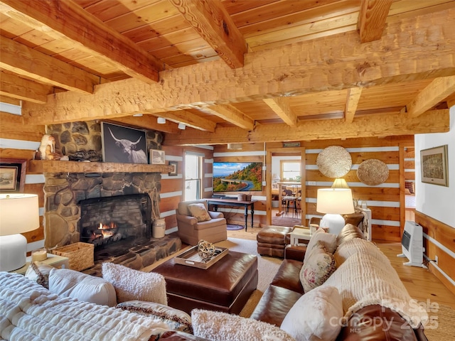 7810 Little Snowbird Rd, Robbinsville, NC 28771 - living area with wood walls, wood-type flooring, a stone fireplace, a wood ceiling with exposed beams, and heating unit