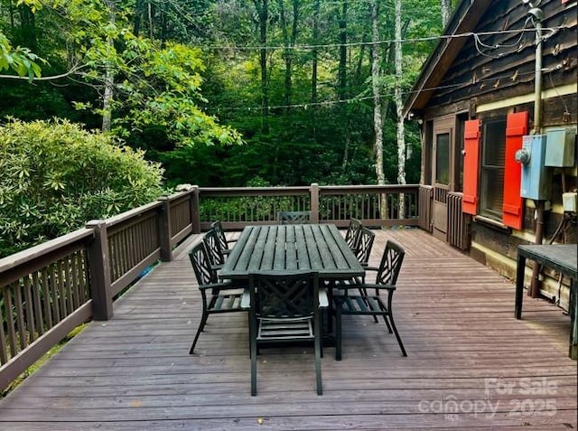 7810 Little Snowbird Rd, Robbinsville, NC 28771 - deck with outdoor dining area and a wooded view
