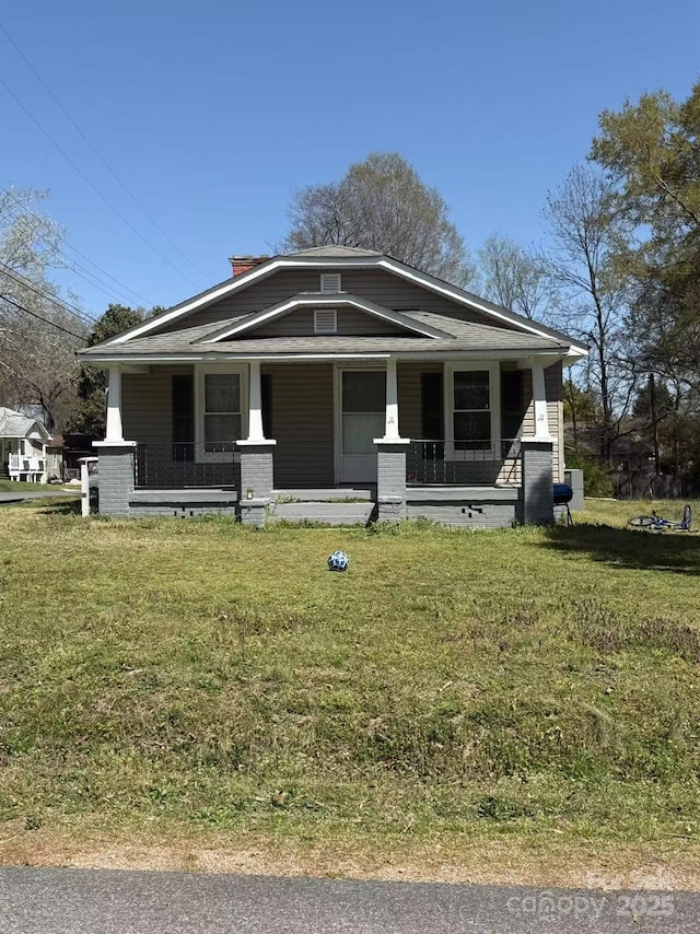 bungalow-style home featuring a porch and a front lawn