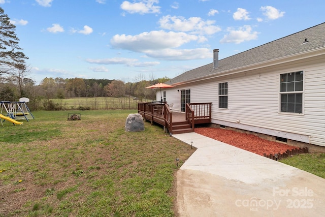 view of yard with a wooden deck and a playground