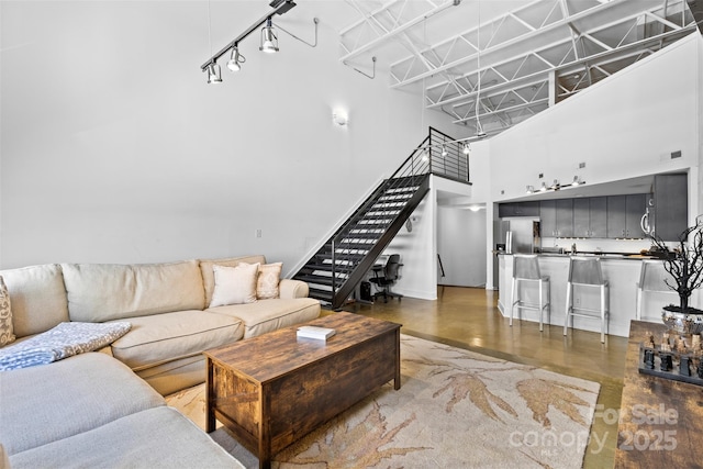 925 Westmere Ave, Charlotte, NC 28208 - living room with stairs, wet bar, baseboards, a high ceiling, and visible vents