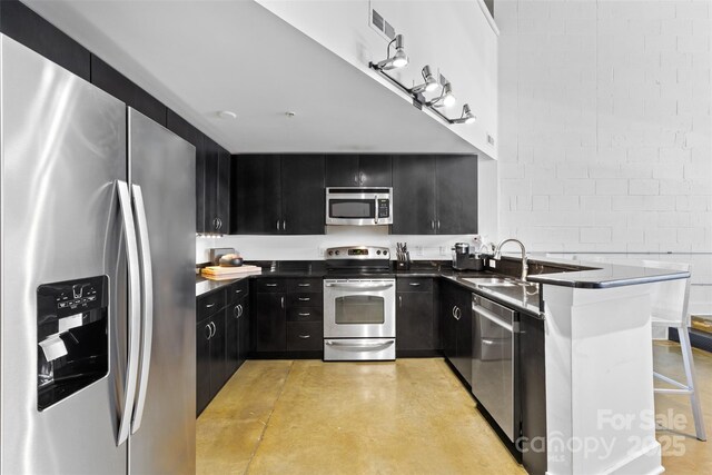 925 Westmere Ave, Charlotte, NC 28208 - kitchen with visible vents, dark countertops, appliances with stainless steel finishes, a sink, and dark cabinets