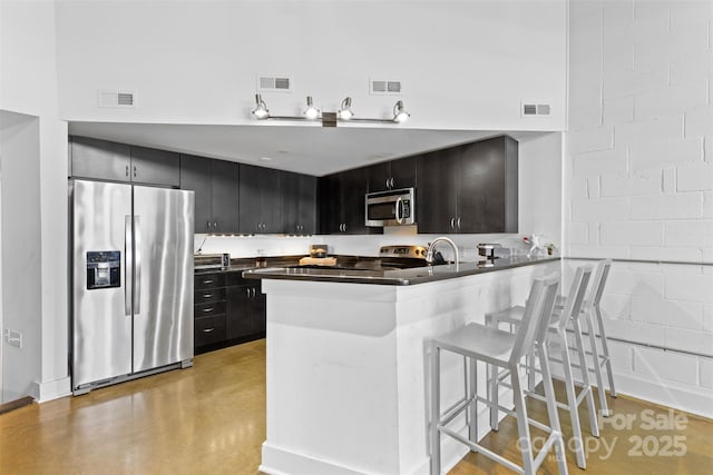 925 Westmere Ave, Charlotte, NC 28208 - kitchen with visible vents, stainless steel appliances, and dark cabinets
