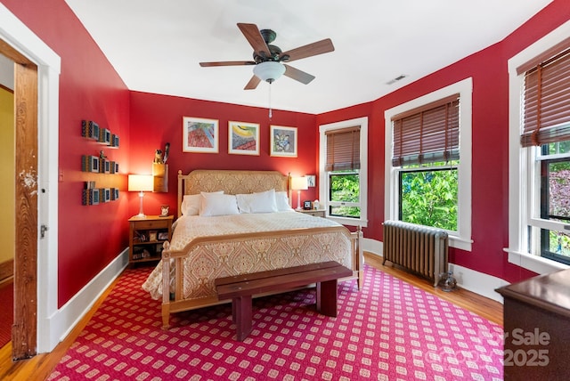 156 Cumberland Ave, Asheville, NC 28801 - bedroom with radiator, wood finished floors, baseboards, and a ceiling fan