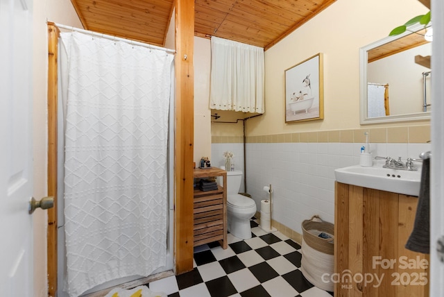 156 Cumberland Ave, Asheville, NC 28801 - full bath featuring tile patterned floors, wooden ceiling, vanity, toilet, and wainscoting