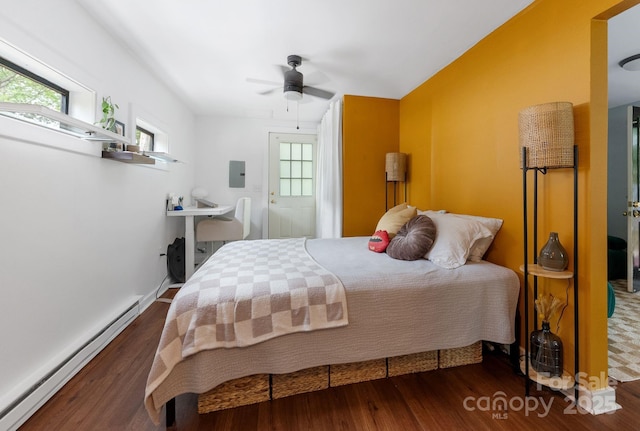 156 Cumberland Ave, Asheville, NC 28801 - bedroom featuring a baseboard heating unit, electric panel, wood finished floors, and multiple windows