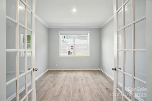 unfurnished room featuring ornamental molding, french doors, and wood finished floors