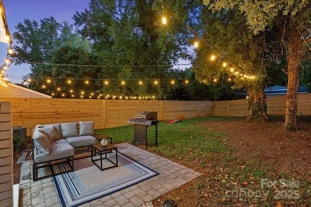 view of yard featuring a fenced backyard, an outdoor living space, and a patio area