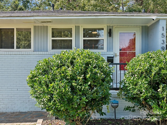 property entrance with brick siding