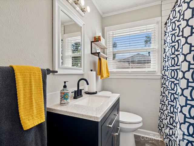 bathroom featuring crown molding, toilet, vanity, a shower with curtain, and baseboards