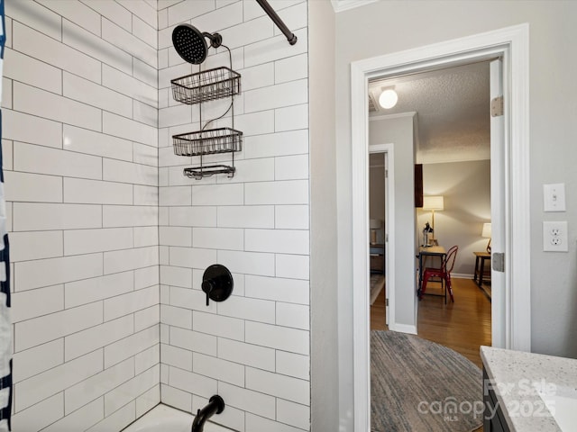 full bathroom with vanity, shower / bathtub combination, wood finished floors, baseboards, and ornamental molding
