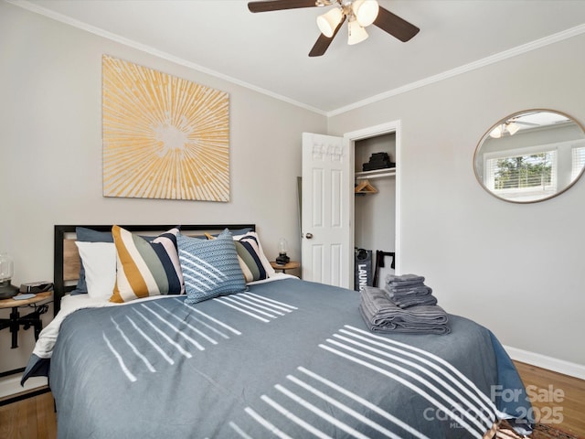 bedroom with ornamental molding, baseboards, ceiling fan, and wood finished floors