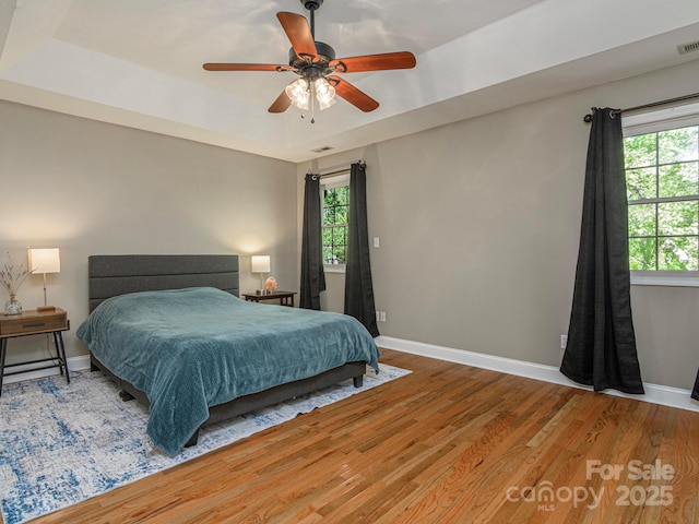 102 Galloway Dr, Asheville, NC 28803 - bedroom featuring a raised ceiling, baseboards, wood finished floors, and visible vents