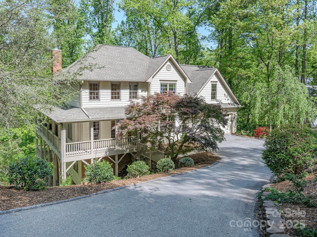 102 Galloway Dr, Asheville, NC 28803 - view of front facade featuring a shingled roof, covered porch, a chimney, and driveway