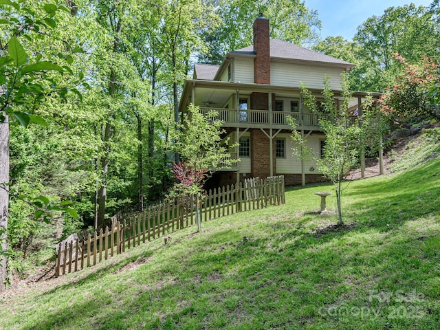 102 Galloway Dr, Asheville, NC 28803 - back of property featuring a lawn, a wooden deck, fence, and a chimney