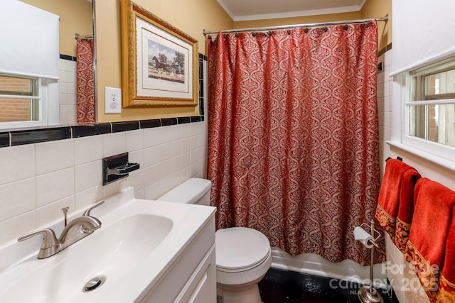 full bath with toilet, crown molding, vanity, and tile walls