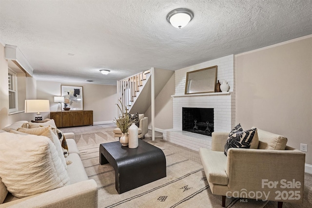 carpeted living room with a textured ceiling, a brick fireplace, baseboards, ornamental molding, and stairway