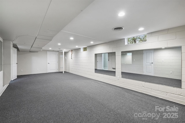 below grade area with visible vents, recessed lighting, and dark colored carpet