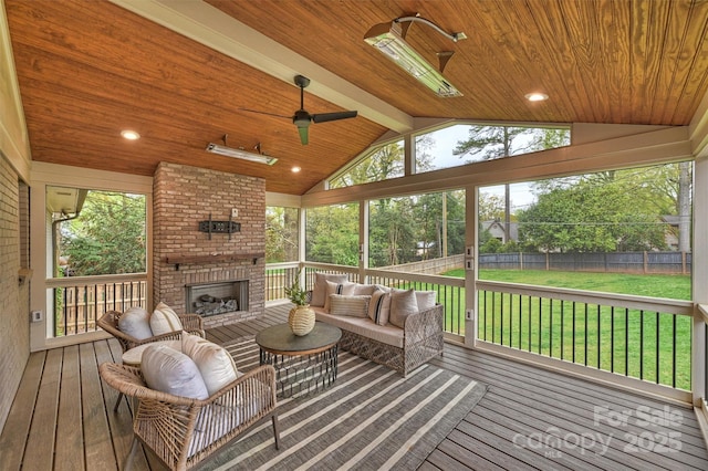 wooden terrace with fence, an outdoor living space with a fireplace, ceiling fan, and a lawn