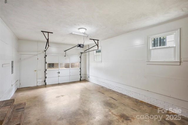 garage featuring electric panel and a garage door opener