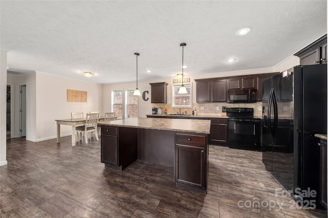 kitchen with dark brown cabinetry, backsplash, a kitchen island, dark wood-style floors, and black appliances