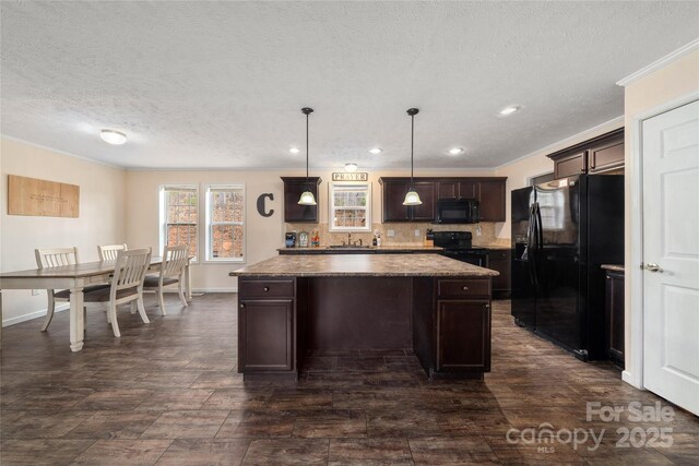 kitchen with ornamental molding, a center island, backsplash, dark brown cabinets, and black appliances