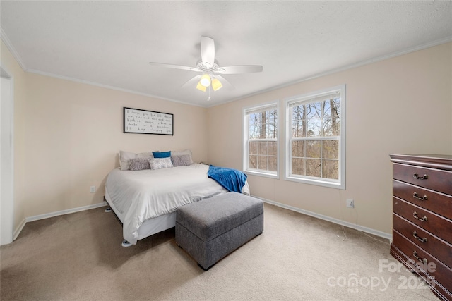 bedroom featuring light colored carpet, ceiling fan, baseboards, and ornamental molding