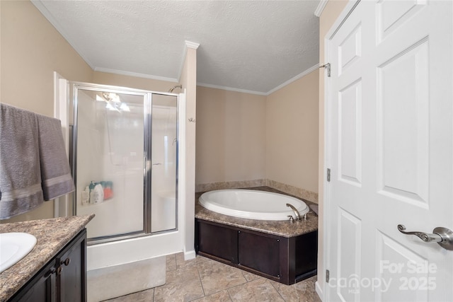 bathroom featuring vanity, ornamental molding, a textured ceiling, a stall shower, and a garden tub