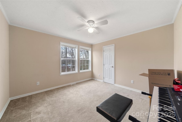 interior space with crown molding, a textured ceiling, baseboards, ceiling fan, and carpet