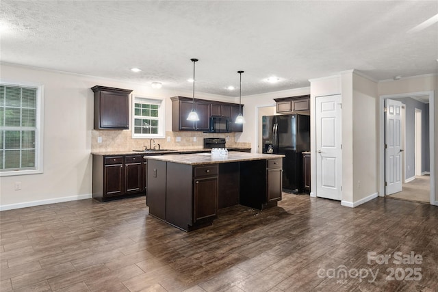 61 Evelyn Acres Dr, Asheville, NC 28806 - kitchen featuring black appliances, ornamental molding, dark brown cabinets, tasteful backsplash, and a kitchen island