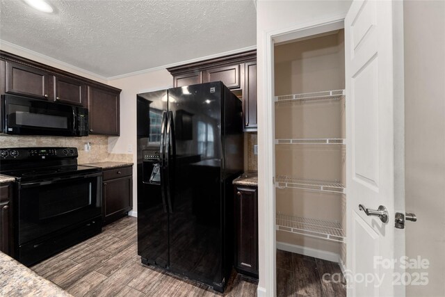 61 Evelyn Acres Dr, Asheville, NC 28806 - kitchen with black appliances, dark brown cabinets, wood finished floors, decorative backsplash, and a textured ceiling