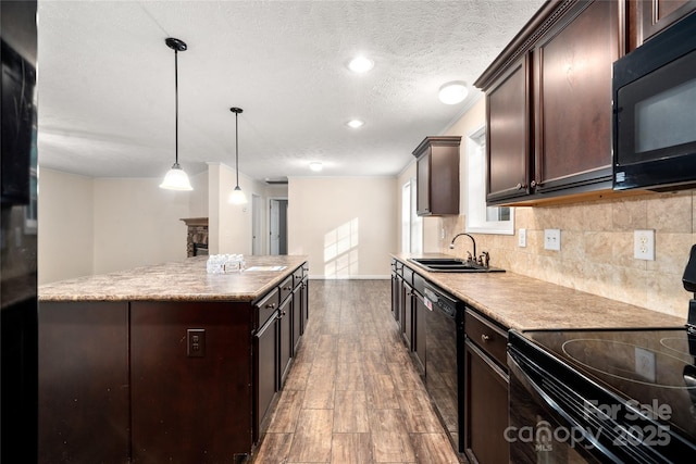 61 Evelyn Acres Dr, Asheville, NC 28806 - kitchen with black appliances, wood finished floors, dark brown cabinets, tasteful backsplash, and a textured ceiling