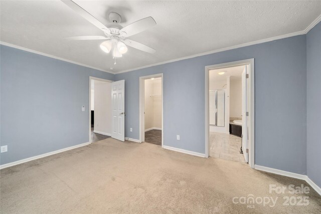 61 Evelyn Acres Dr, Asheville, NC 28806 - unfurnished bedroom with a walk in closet, carpet flooring, crown molding, a closet, and connected bathroom