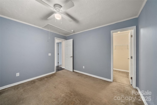 61 Evelyn Acres Dr, Asheville, NC 28806 - unfurnished bedroom with attic access, carpet flooring, a walk in closet, crown molding, and a textured ceiling